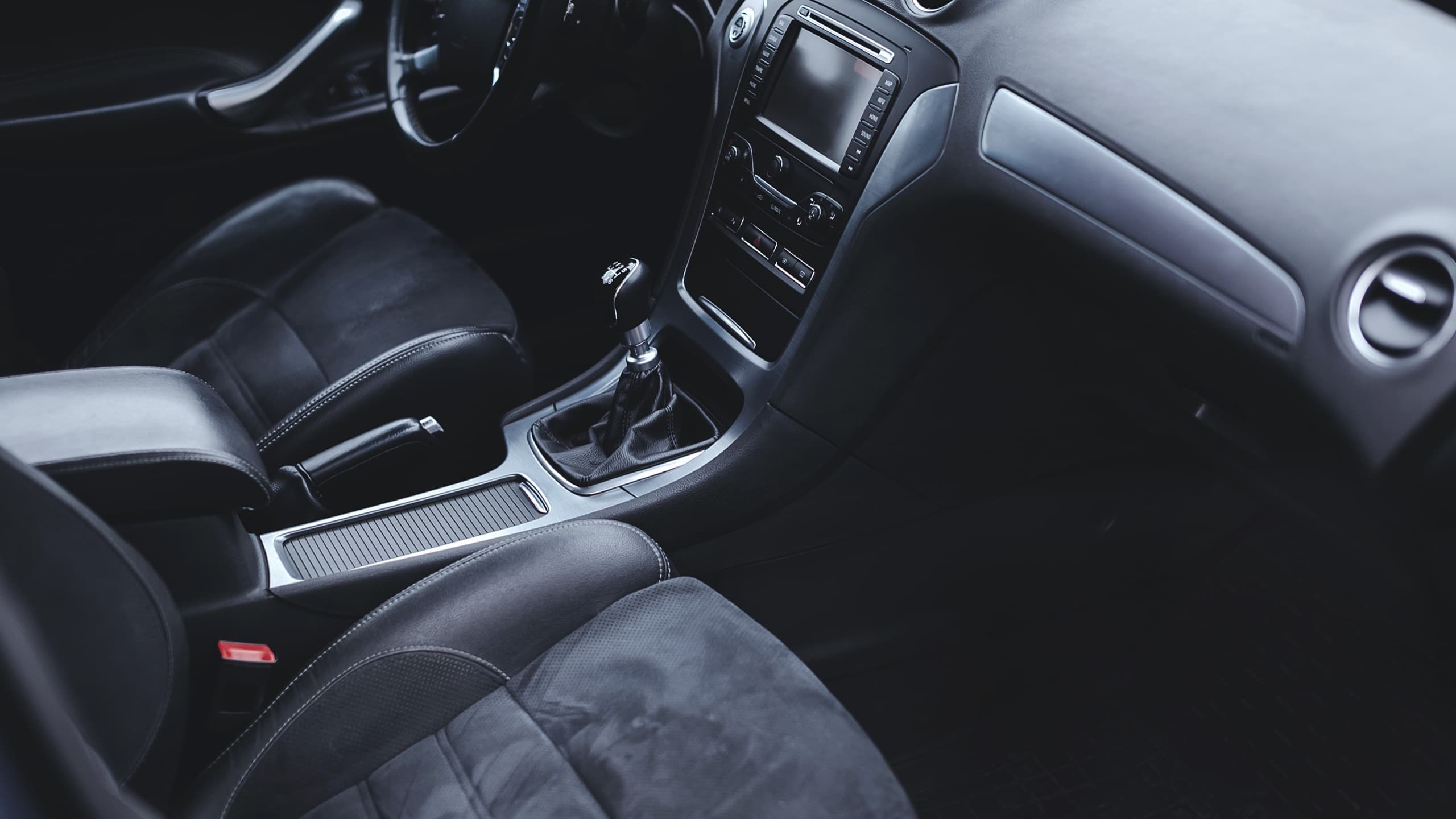 Clean detailed car interior with suede seats and center console after Auto Gleam Details add-on services