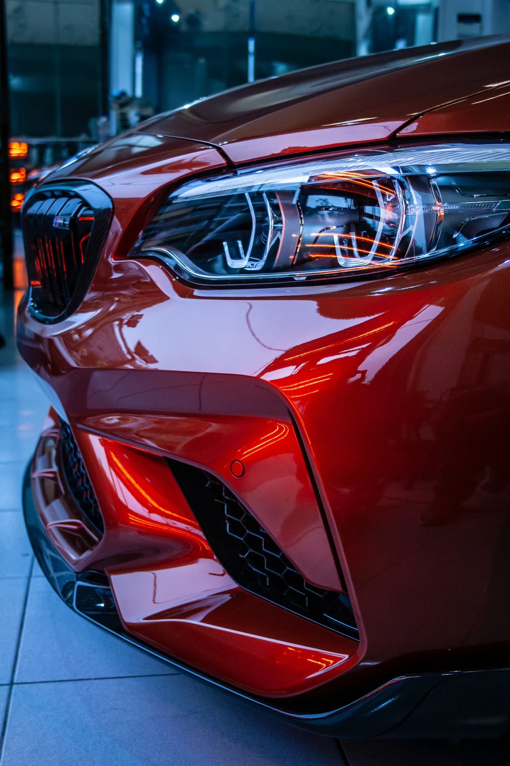 Gleaming dark red sports car after an Auto Gleam Details service