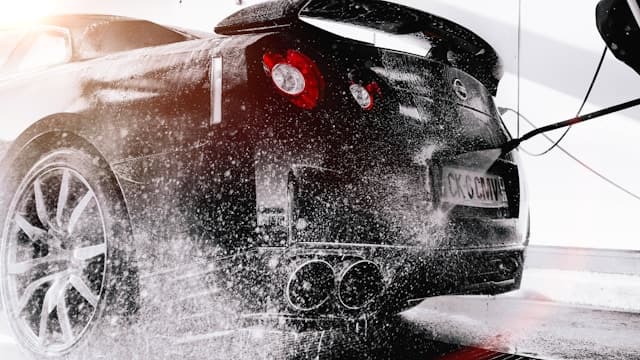 Detailer polishing a car panel
